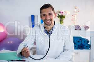 Portrait of physiotherapist holding stethoscope