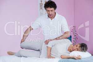 Physiotherapist massaging a senior womans leg