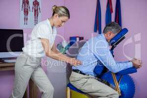 Physiotherapist giving back massage to a patient