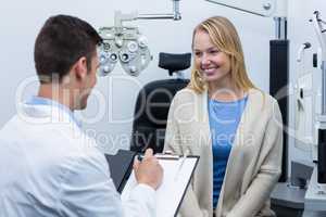 Optometrist consulting female patient