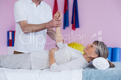 Physiotherapist massaging a senior womans hand