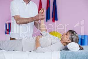 Physiotherapist massaging a senior womans hand