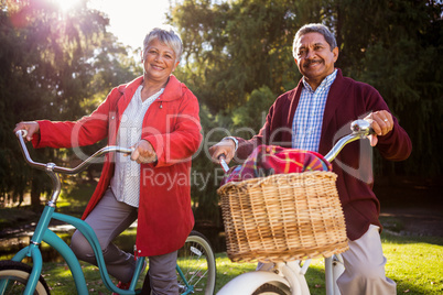 Smiling mature couple with bicycle