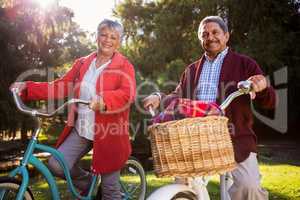 Smiling mature couple with bicycle