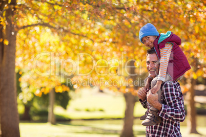 Portrait of father carrying son on shoulder