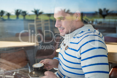 Smiling man holding a coffee cup