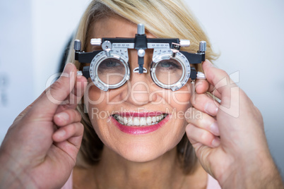 Optometrist examining female patient with messbrille