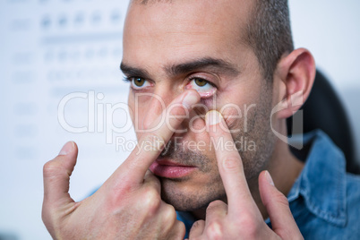 Man applying contact lens