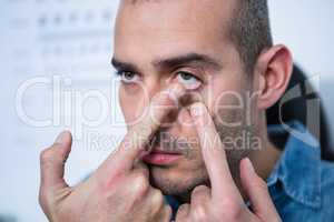 Man applying contact lens