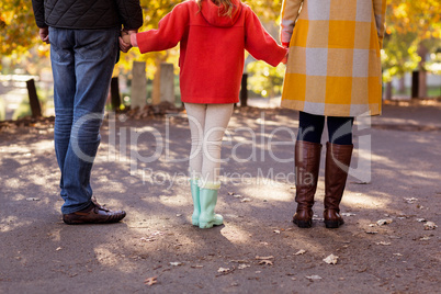 Girl with parents on road