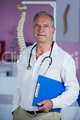 Portrait of physiotherapist holding clipboard