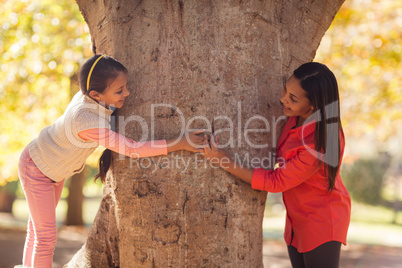 Side view of playful mother with daughter at park