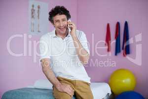 Portrait of physiotherapist talking on mobile phone