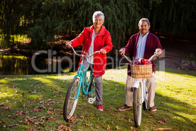 Mature couple riding bicycle at park