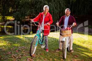 Mature couple riding bicycle at park