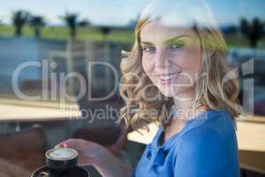 Smiling woman holding a coffee cup