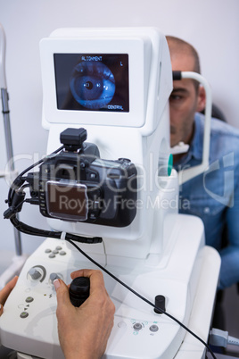 Man looking at eye test machine