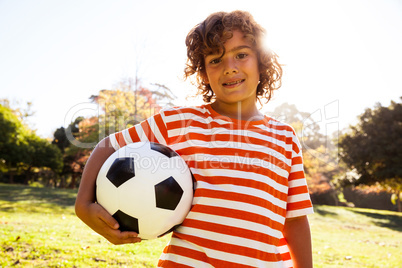 Portrait of smiling boy holding soccer ball