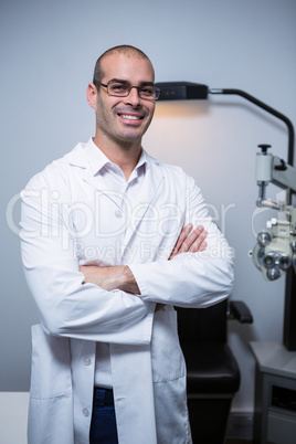 Portrait of male optometrist with arms crossed
