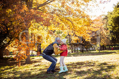 Father with daughter at park during autumn