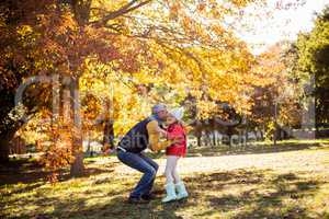 Father with daughter at park during autumn