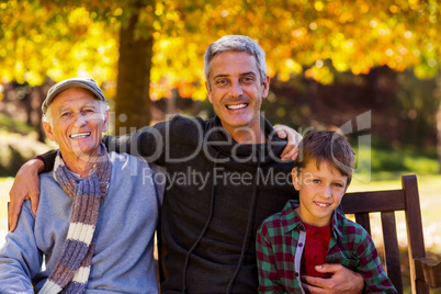 Man with father and son sitting at park