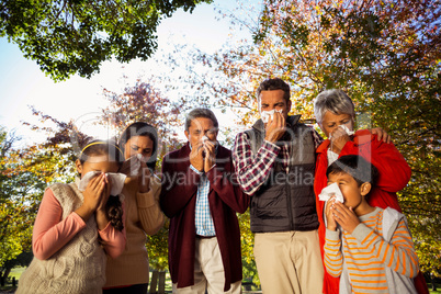 Low angle view of sick family blowing their noses
