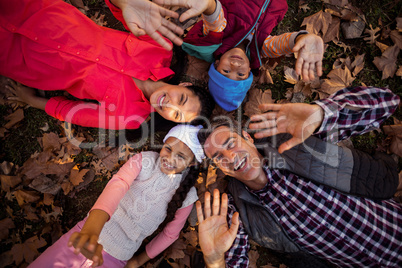 Overhead view of family gesturing while forming huddle