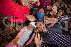 Overhead view of family gesturing while forming huddle