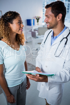 Physiotherapist explaining diagnosis to female patient
