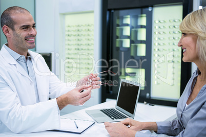 Male optometrist talking to female patient