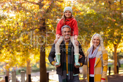 Portrait of daughter with parents at park