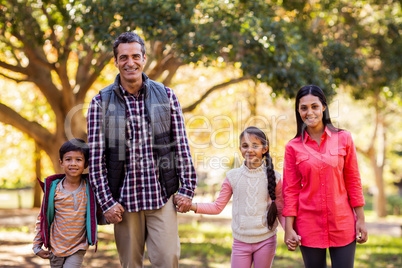 Portrait of family holding hands at park