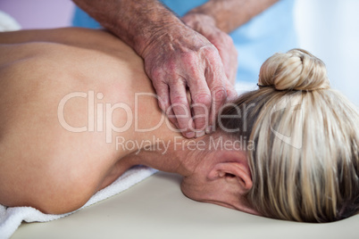 Woman receiving neck massage from physiotherapist