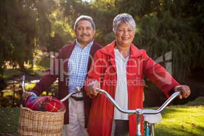 Happy mature couple with bicycle