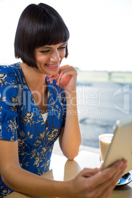 Woman using a digital tablet in the coffee shop