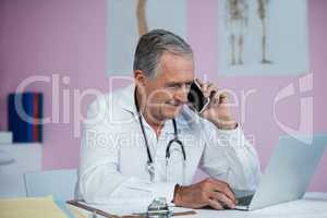Physiotherapist talking on mobile phone
