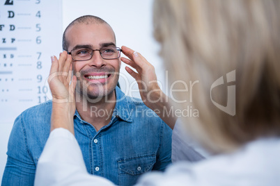 Female optometrist prescribing spectacles to patient