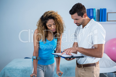 Physiotherapist showing report to the patient