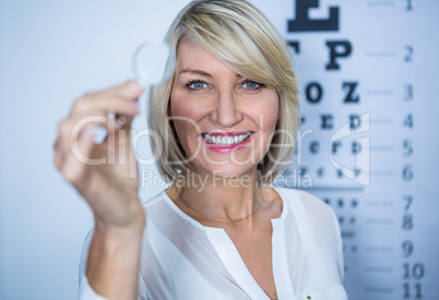 Female patient holding magnifying glass
