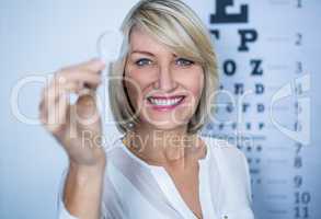 Female patient holding magnifying glass