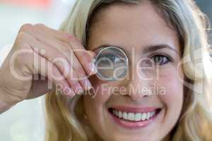 Female customer looking through magnifying glass