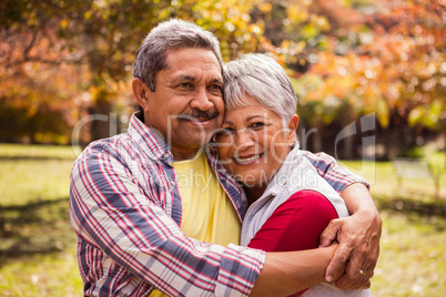 Smiling elderly couple gets hugs