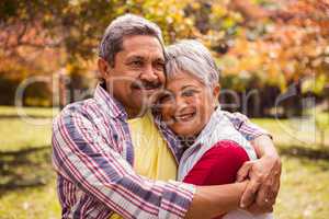 Smiling elderly couple gets hugs