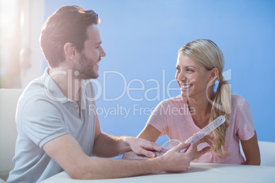 Physiotherapist examining female patients wrist with goniometer