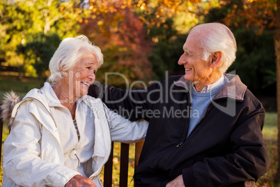 Senior couple embracing on a bench