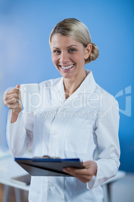 Physiotherapist holding a medical report while having coffee