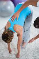 Physiotherapist examining womans back