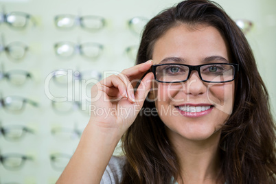 Female customer wearing spectacles in optical store