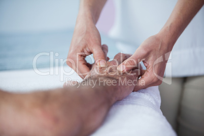 Physiotherapist giving hand massage to a patient